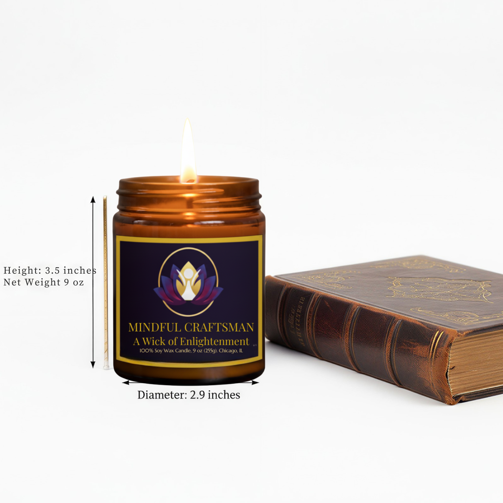 Mindful Craftsman candle with a 'Wick of Enlightenment' label next to a vintage leather-bound book, showing technical measurements: 3.5 inches height, 9 oz net weight, and 2.9 inches diameter on a white background.