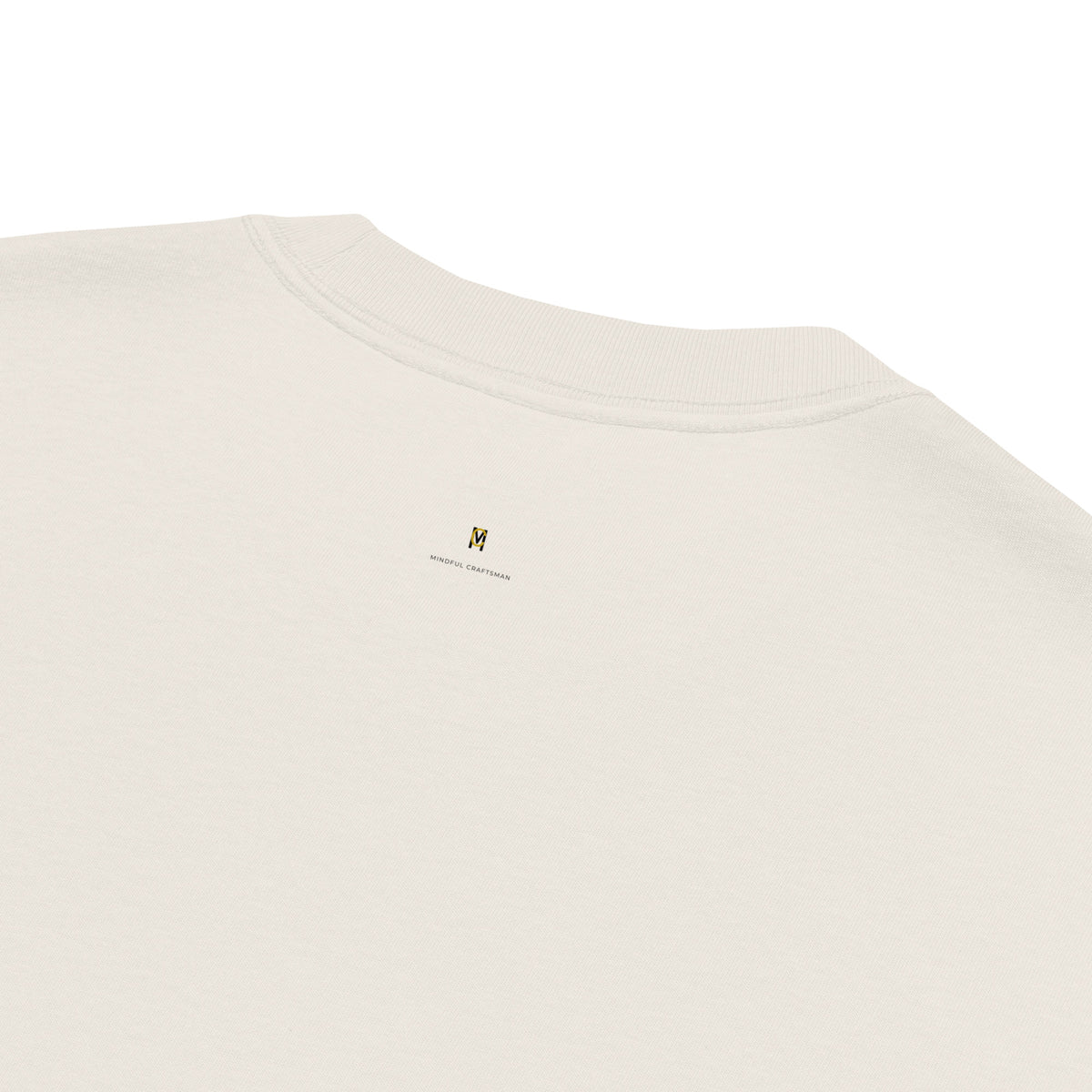 Close-up rear view of the back neck collar on the faded bone oversized t-shirt showing the small Mindful Craftsman logo.